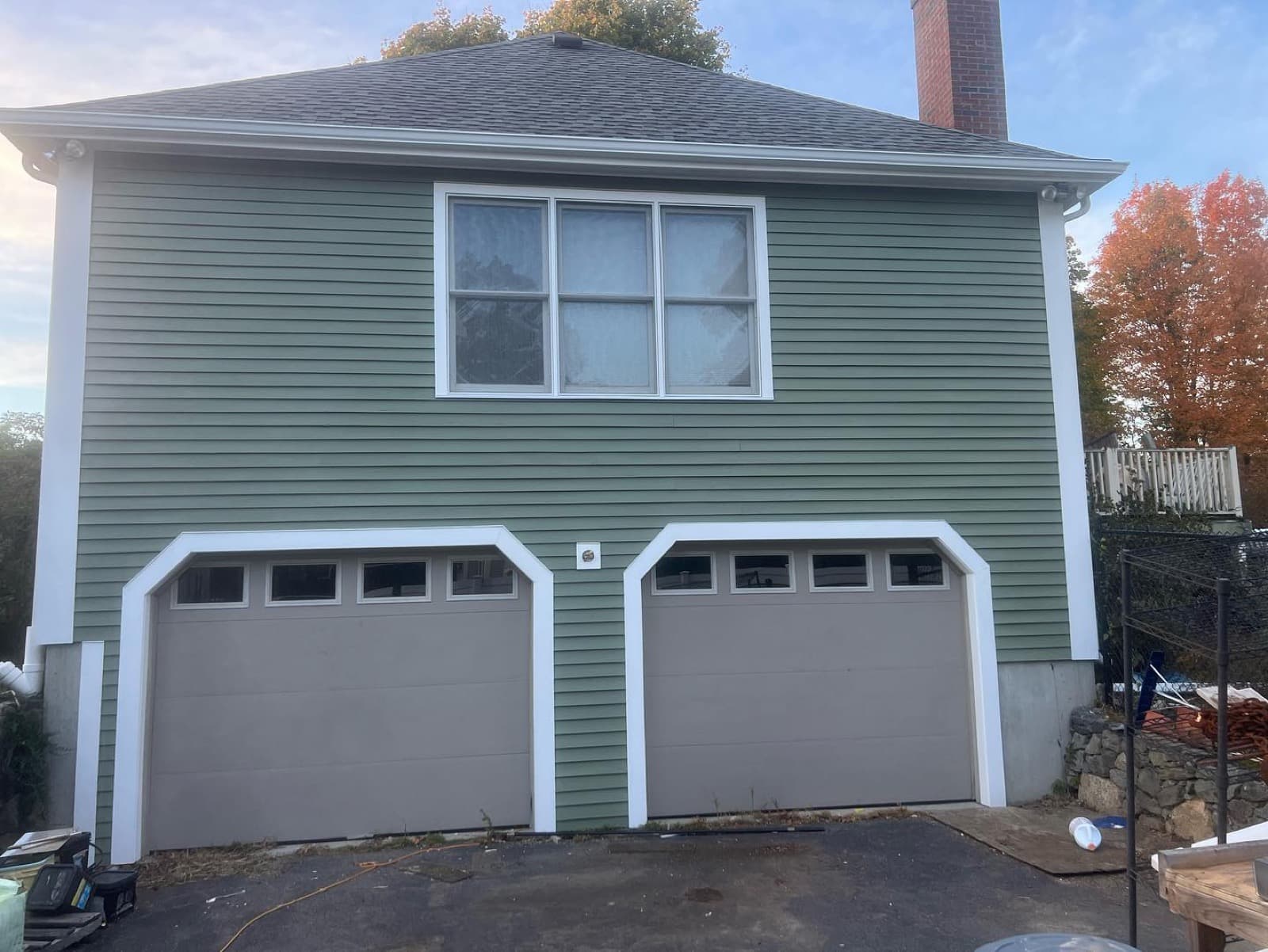 Freshly painted coastal home exterior with attached garage on the North Shore