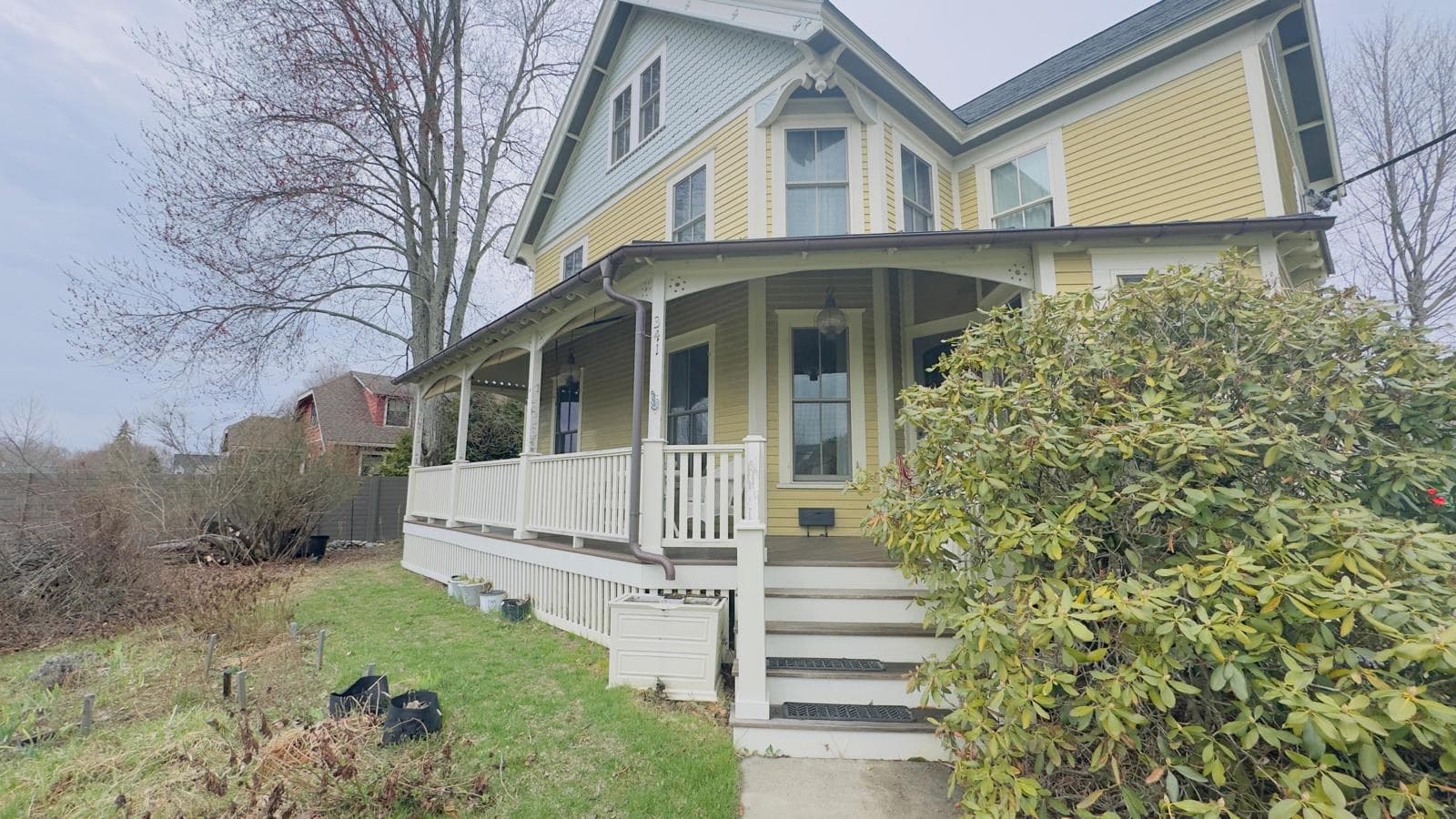 Freshly painted Victorian home with a wraparound porch near the coast in Beverly, Massachusetts